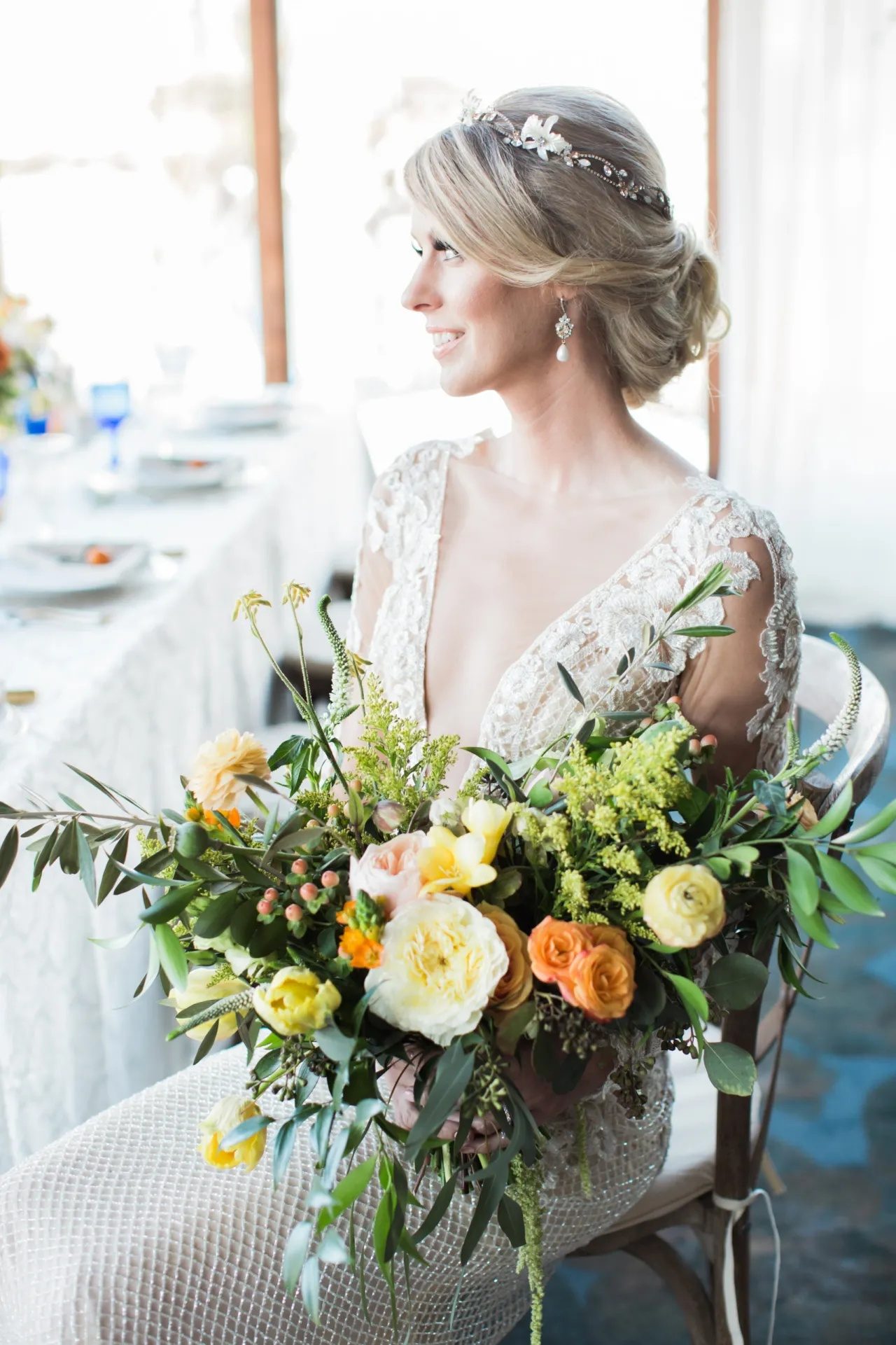 A close portrait of the bride, seated at the table.